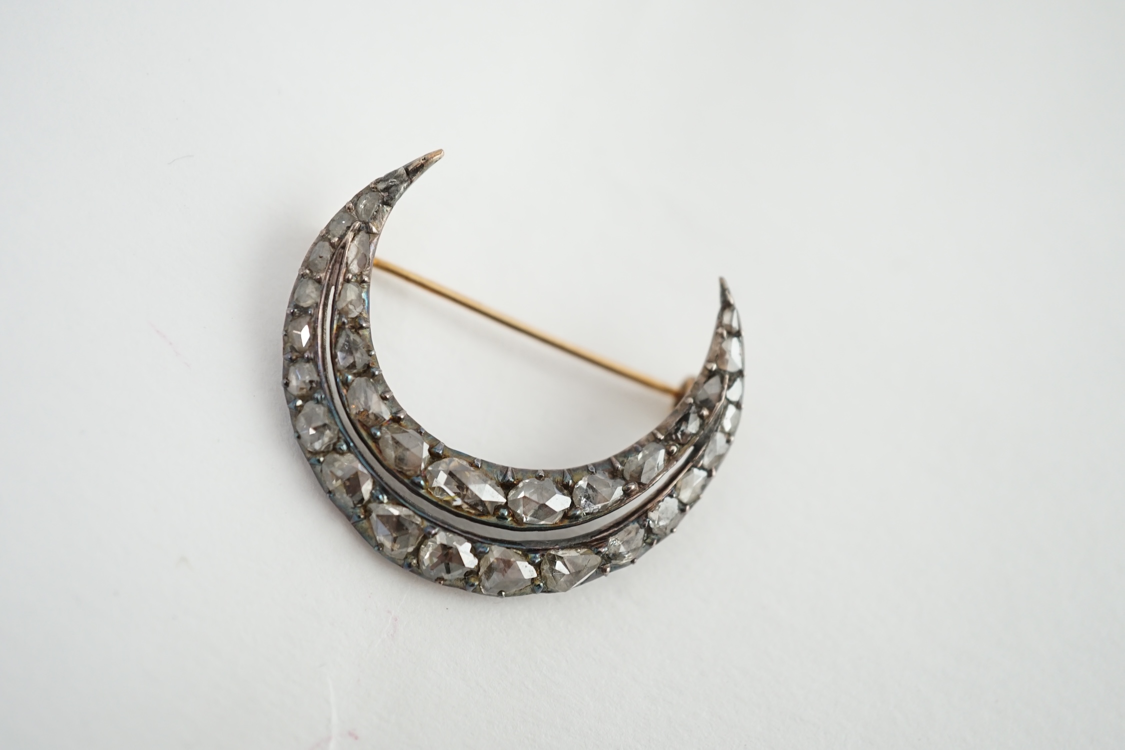 A 19th century gold, silver and graduated rose cut diamond set two row crescent brooch